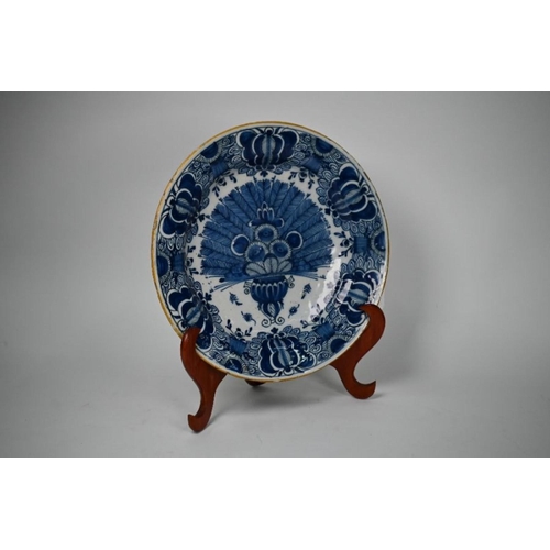 75 - A mid 18th century Dutch Delft De Lampetkan charger, painted with peacock feathers in vase, with fol... 