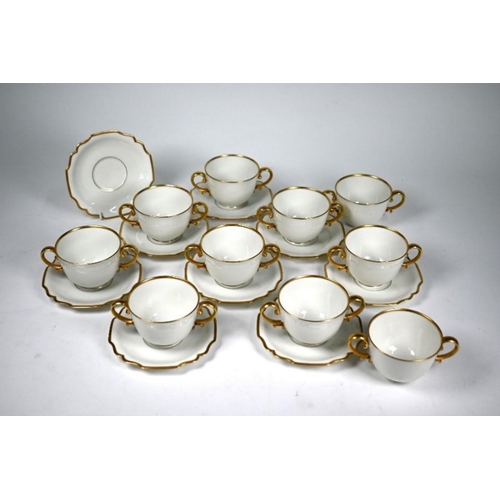 79 - Ten Augarten (Austria) two-handled cups with nine saucers, with gilt handles and rims