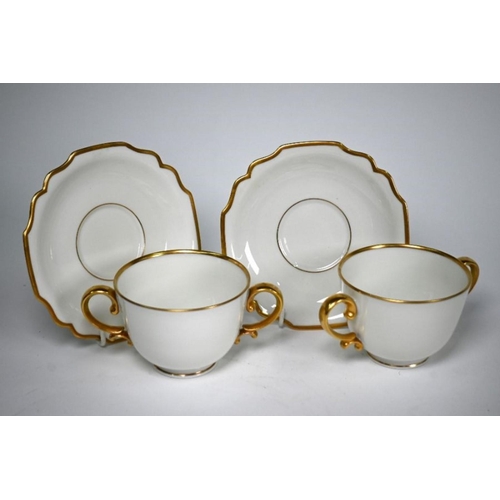 79 - Ten Augarten (Austria) two-handled cups with nine saucers, with gilt handles and rims