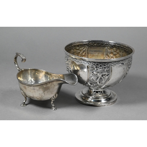 100 - An Edwardian silver rose-bowl with floral embossed decoration, on stemmed foot, Walker & Hall, C... 