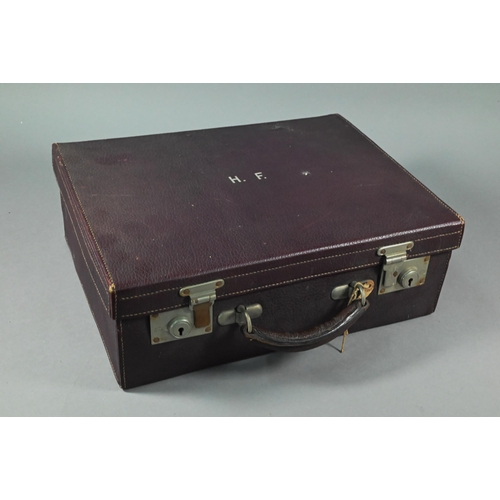 108 - A purple leather small suitcase, the watered silk and Morocco leather lining fitted with five silver... 