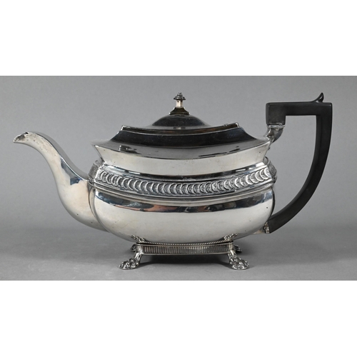 109 - A George III silver teapot with overlapping 'orange segment' lunette frieze, composite handle, on pa... 