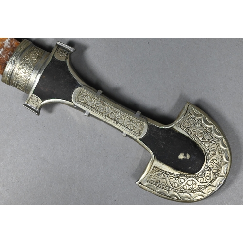 1108 - An Arab dagger Jimbaya with 23 cm curved blade on wooden hilt with engraved low-grade white metal mo... 