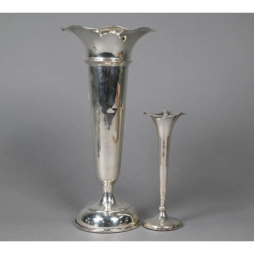 124 - A loaded silver vase-flute, London 1929, 22 cm high to/w a smaller example, a milk jug (marks rubbed... 