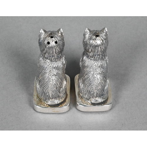 126 - A 925 standard 'Sterling' novelty salt and pepper pair, cast as seated cats with green glass eyes, 5... 