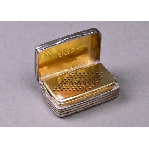 148A - A George III silver vinaigrette with reeded body, the gilt interior with diamond punched inner grill... 