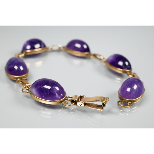 150 - An amethyst bracelet, the six oval cabochon stones with scroll links between, snap clasp, 18 cm long... 