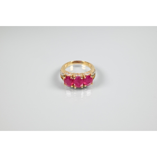 152 - A ruby ring, the three oval rubies claw set, with diamond set gallery and split shoulders, yellow me... 