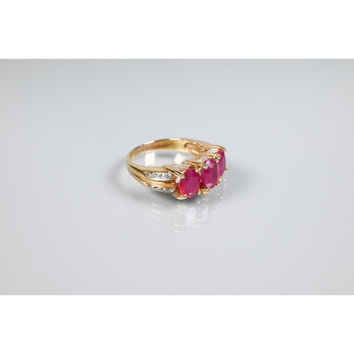 152 - A ruby ring, the three oval rubies claw set, with diamond set gallery and split shoulders, yellow me... 