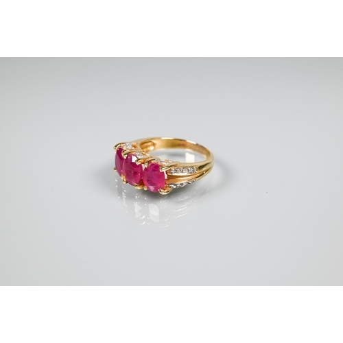 152 - A ruby ring, the three oval rubies claw set, with diamond set gallery and split shoulders, yellow me... 