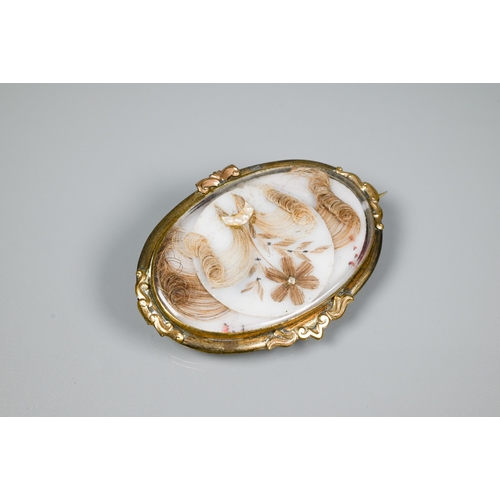 156 - A Victorian brooch featuring hairwork scene of flowers and garlands, 6 x 4 cm and an agate and gilt ... 