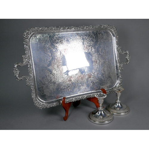 16 - Large epns tray with floral-cast rim and twin handles, to/w a pair of ep candlesticks on broad bases... 