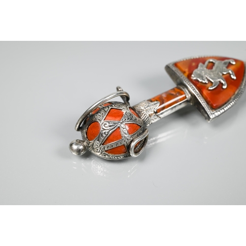 168 - A Scottish kilt pin in the form of a sheathed sword and shield inset with agate, white metal set wit... 