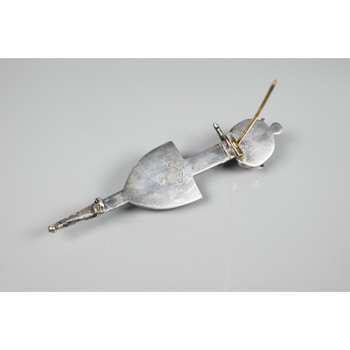 168 - A Scottish kilt pin in the form of a sheathed sword and shield inset with agate, white metal set wit... 