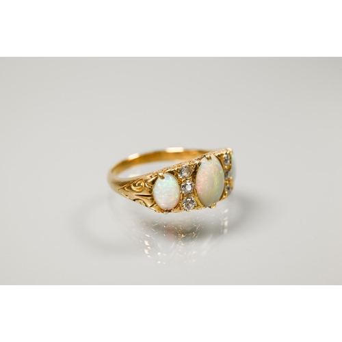 186 - An antique three-stone opal and diamond ring, the graduated opals with three small diamonds between,... 