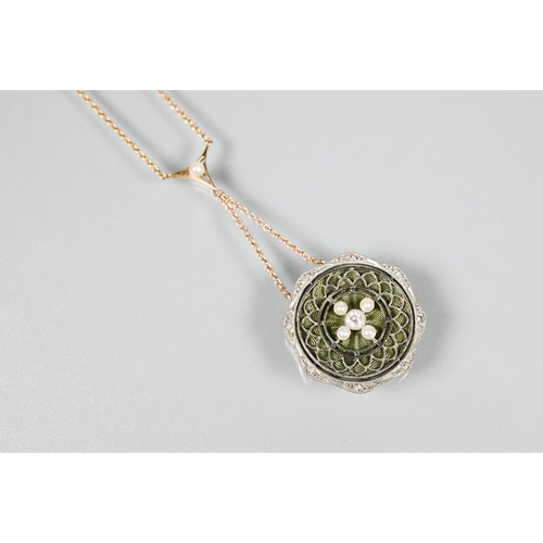 187 - An Edwardian necklace, the circular pendant formed of a fine white metal wirework/filigree surround ... 