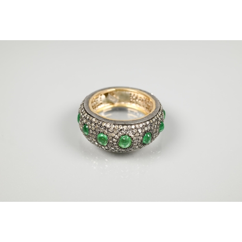 201 - A South African diamond and emerald bombe eternity ring, the pavé set diamonds set with seven gradua... 