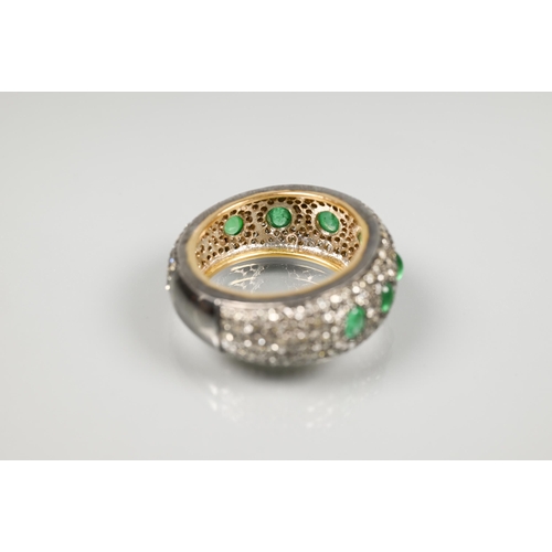 201 - A South African diamond and emerald bombe eternity ring, the pavé set diamonds set with seven gradua... 