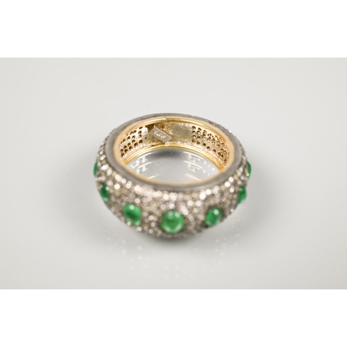 201 - A South African diamond and emerald bombe eternity ring, the pavé set diamonds set with seven gradua... 