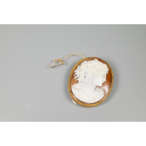 206 - A well-carved oval shell cameo, featuring woman with elaborate hair garland, in 9ct gold rope and pl... 