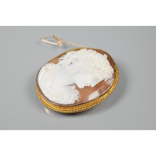 206 - A well-carved oval shell cameo, featuring woman with elaborate hair garland, in 9ct gold rope and pl... 