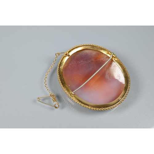 206 - A well-carved oval shell cameo, featuring woman with elaborate hair garland, in 9ct gold rope and pl... 