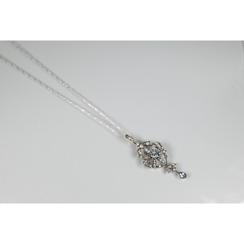 211 - An Edwardian foliate and scroll pendant, the open flower set overall with diamonds and with a centra... 