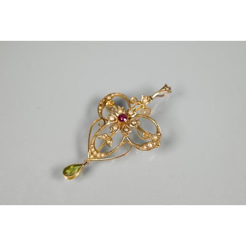 217 - An Art Nouveau flower and scroll open pendant, set overall with seed pearls and with central ruby, w... 