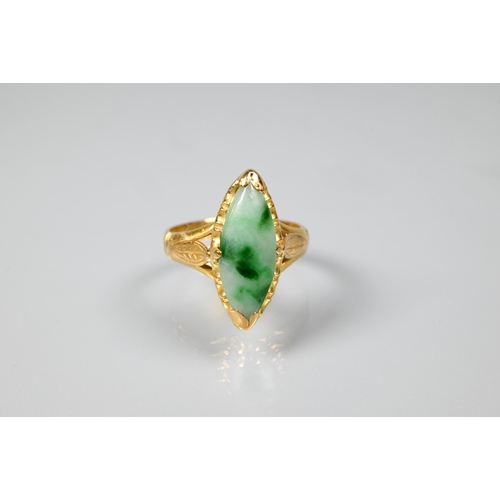 222 - A marquis-shaped green jade set ring, unmarked yellow metal, with engraved shoulders, size M