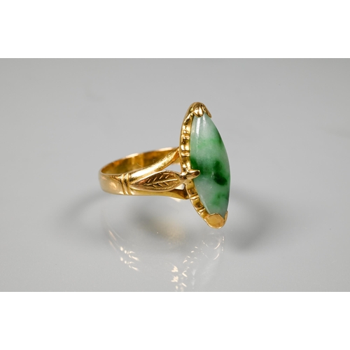 222 - A marquis-shaped green jade set ring, unmarked yellow metal, with engraved shoulders, size M