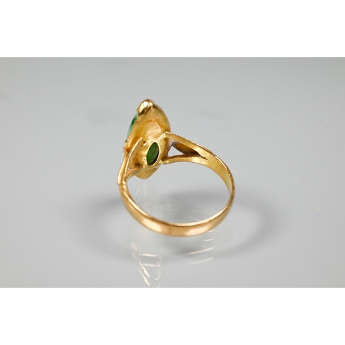 222 - A marquis-shaped green jade set ring, unmarked yellow metal, with engraved shoulders, size M