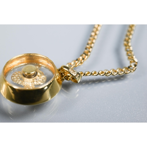 223 - A Chopard-style 'Happy' snake pendant with rotating diamond-set serpent within, yellow metal stamped... 