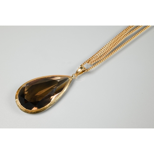 224 - A suite of smokey quartz jewellery comprising large tear drop pendant in yellow metal mount stamped ... 