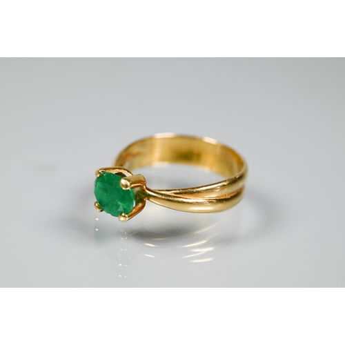 227 - An oval included green emerald ring in high prong setting, and conjoined shank, yellow metal stamped... 