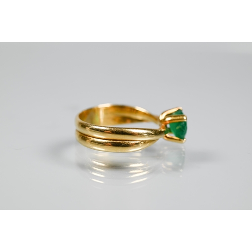 227 - An oval included green emerald ring in high prong setting, and conjoined shank, yellow metal stamped... 