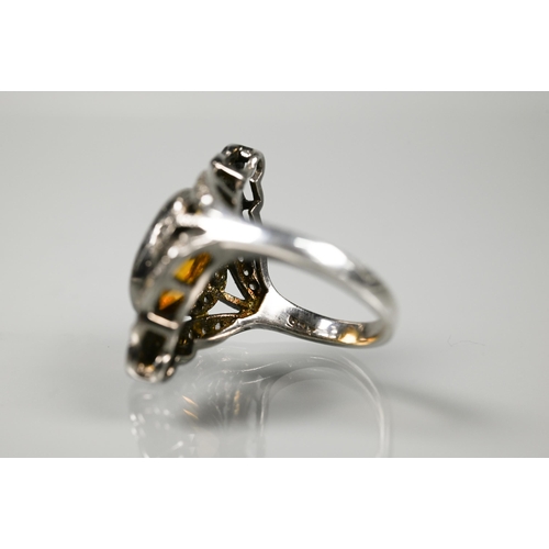 232 - A statement diamond and citrine cluster ring, the oval citrine with pavé set diamonds in Gothic-styl... 