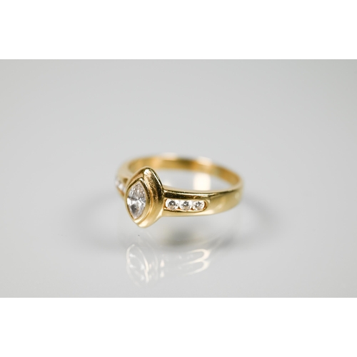 234 - A contemporary style ring with elliptical collet set diamond to the centre, with three graduated dia... 