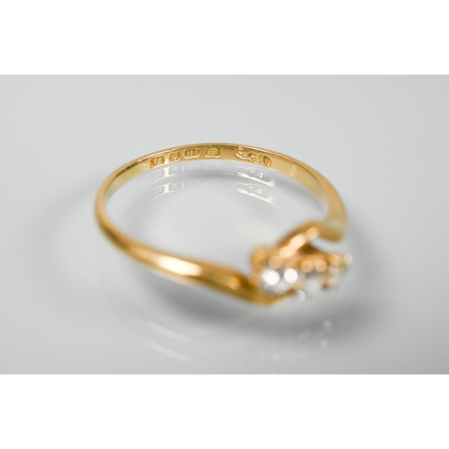 239 - A three-stone diamond ring in crossover setting, 18 ct yellow gold, size R 1/2, to/w an old narrow 2... 