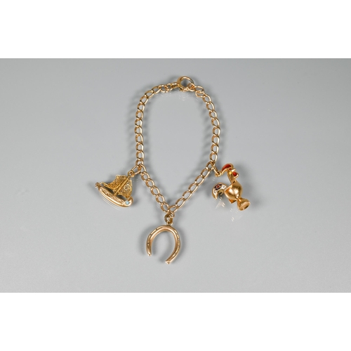 241 - A yellow metal curb bracelet with 10ct horseshoe, Portuguese cockerel, and dinghy attached, 11.5g al... 