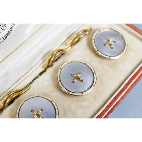 247 - A cased set of four mother of pearl dress buttons and split rings, 18ct yellow gold set, in original... 