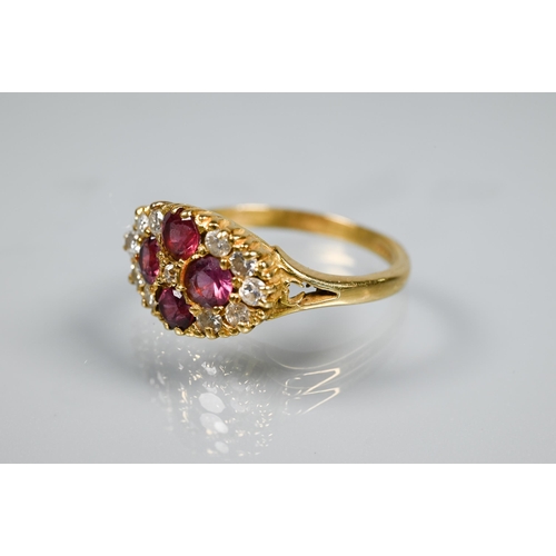 253 - An antique garnet and diamond cluster ring formed of four circular garnets with eleven diamonds arou... 