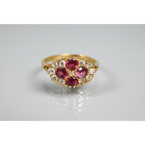 253 - An antique garnet and diamond cluster ring formed of four circular garnets with eleven diamonds arou... 