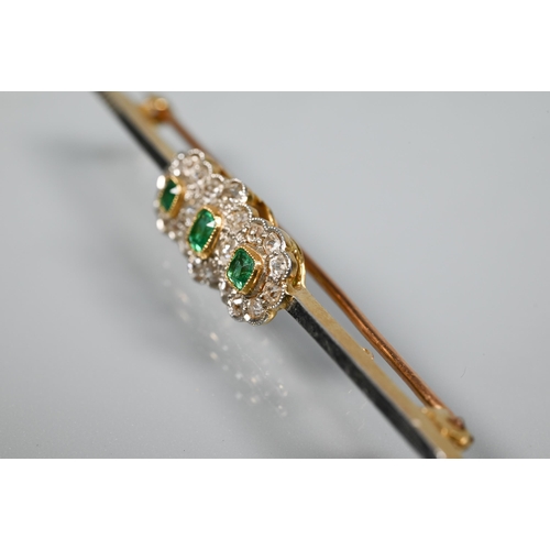 255 - A diamond and emerald cluster bar brooch formed of three conjoined circular clusters, milgrain set, ... 