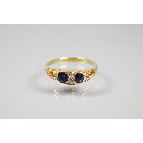 256 - A 14ct yellow gold ring set with two blue sapphires and four small diamonds, size P, approx 2.5g all... 