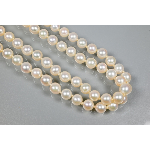 271 - A double row of circular cultured pearls, double knotted throughout onto white metal and diamond set... 