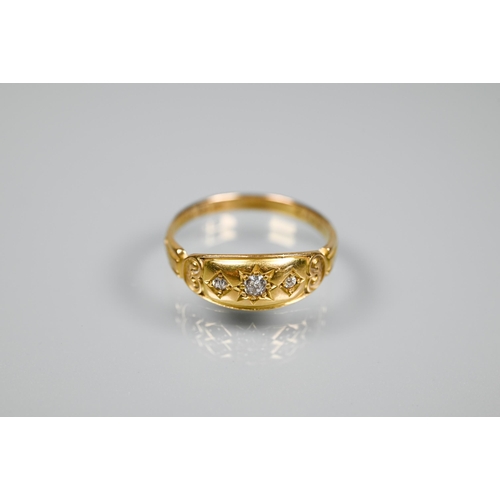 272 - A Victorian gypsy ring, 18ct yellow gold set with three graduated diamonds, and carved shoulders, si... 