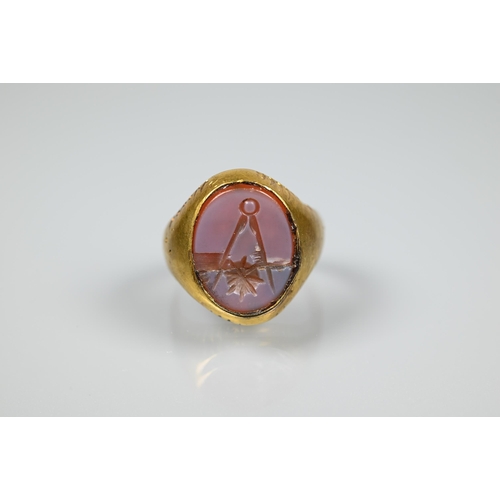 273 - A Masonic signet ring, yellow metal set with chalcedony, size N (stone cracked)