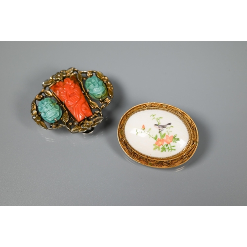 274 - An Oriental vintage part buckle set carved coral and turquoise to/w an oval ceramic set brooch featu... 