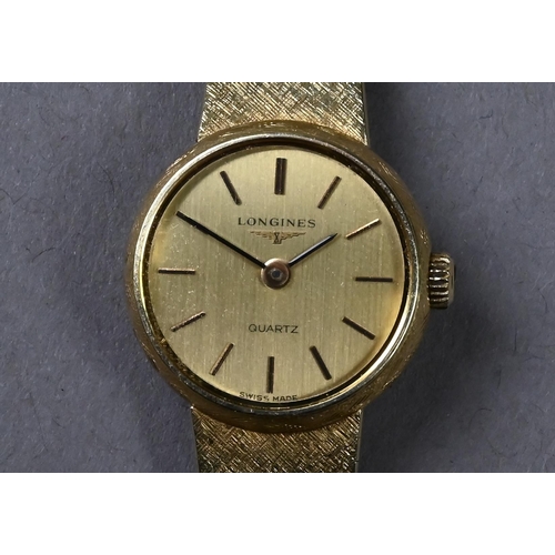 276 - A lady's 14k Longines wristwatch with 17cm champagne dial and quartz movement, on lightly-textured m... 