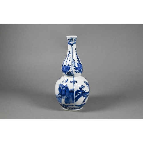 286 - A 19th century Chinese blue and white double gourd vase painted in underglaze blue with flowering br... 